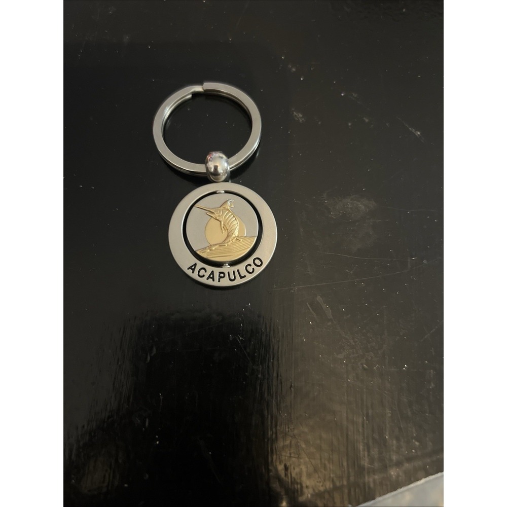 round metal Acapulco‎ souvenir keychain featuring a sailfish design